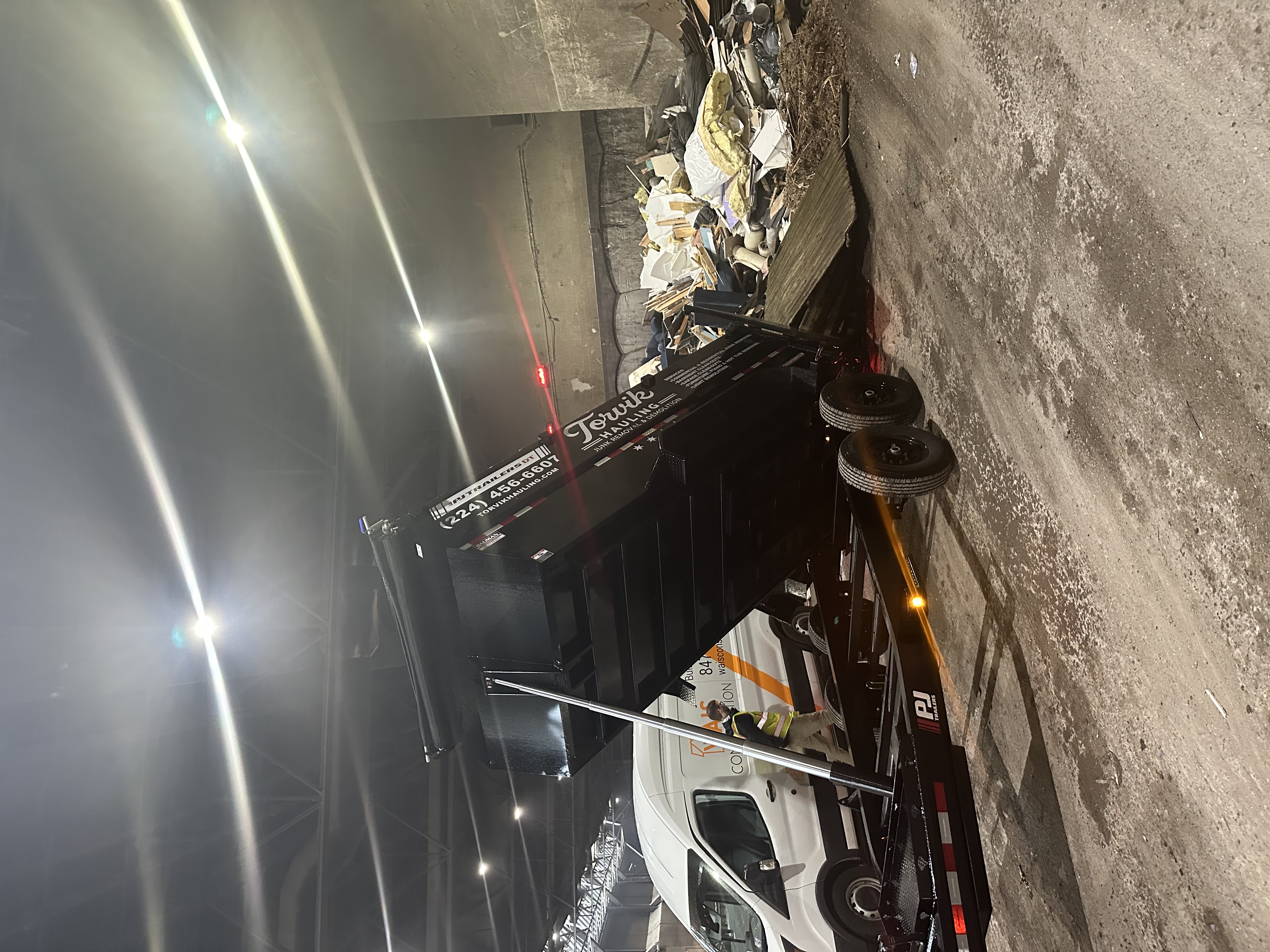 Torvik Hauling dump trailer unloading construction and household debris at a licensed waste transfer station